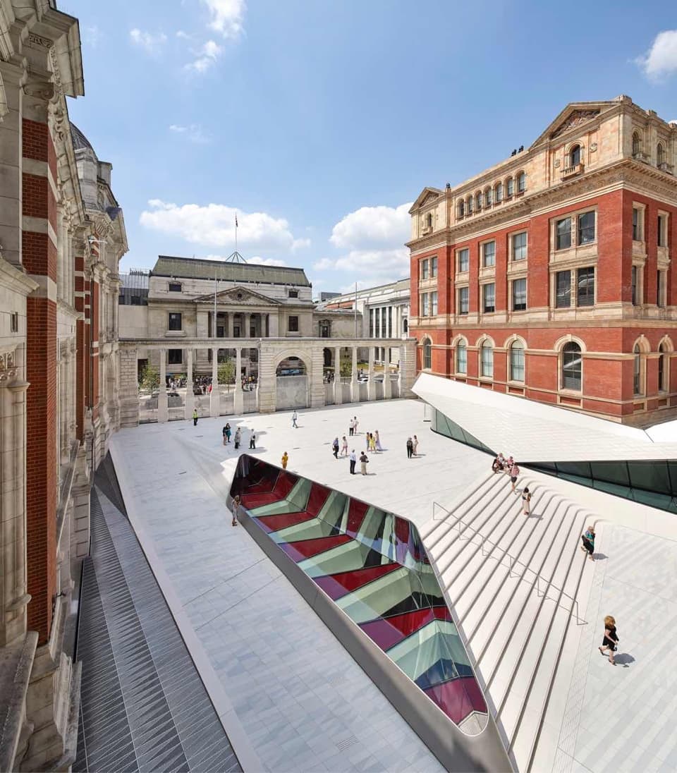Courtyard at V&A Museum showing aluminium gates and people walking